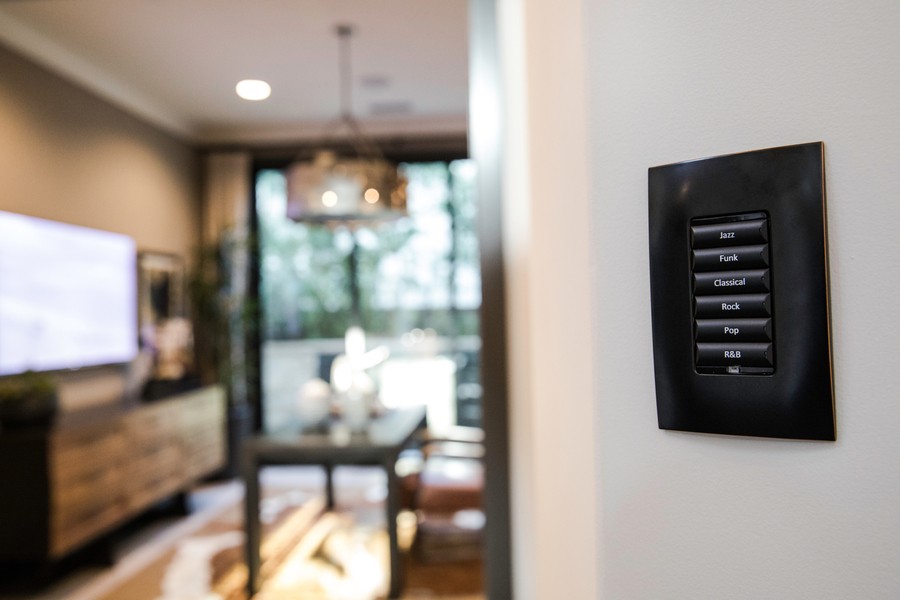 Closeup of a Control4 wall-mounted AV system control interface. 