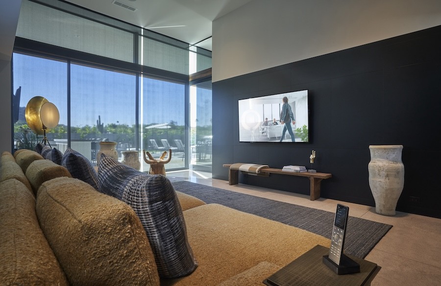 Sheer blinds drawn over floor-to-ceiling windows in a living room.